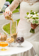 Wedding traditions. A full glass of cereals. Wheat, beans, bread and honey.
