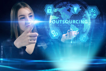 Business, Technology, Internet and network concept. Young businessman working on a virtual screen of the future and sees the inscription: Outsourcing