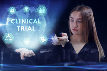 Business, Technology, Internet and network concept. Young businessman working on a virtual screen of the future and sees the inscription: Clinical trial