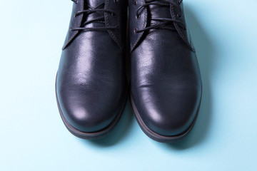 Men's black shoes on a blue background
