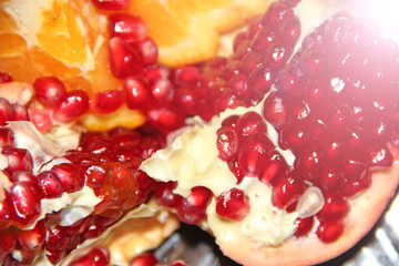Orange segments and ripe seeds of pomegranate. delicious fruits