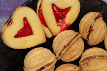 Pastry in shape of hearts and huts with sweet filling.