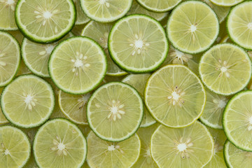 Fototapeta na wymiar A slice of fresh juicy green lemons. Texture background, pattern.