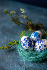 Easter eggs in a nest on a blue background.