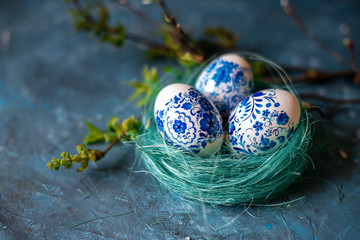 Easter eggs in a nest on a blue background.