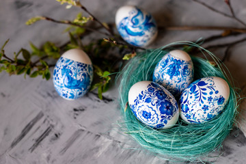 Easter eggs in a nest on a gray background.