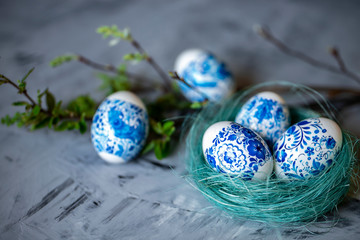 Easter eggs in a nest on a gray background.