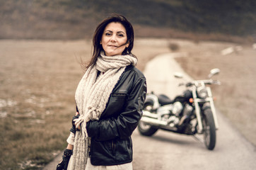 Fototapeta na wymiar Young woman on a motorcycle on the roud 