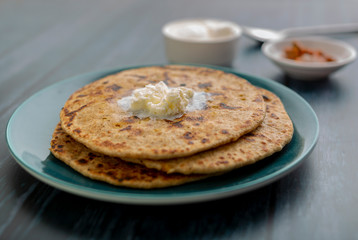 stuffed dal paratha with curd, pickle and white butter 