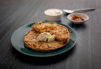 stuffed dal paratha with curd, pickle and white butter 