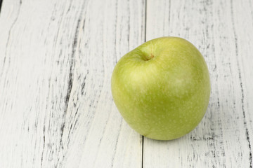 green apple on wooden table