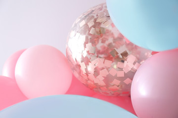 Beautiful colorful balloons on light background, closeup. Party decor