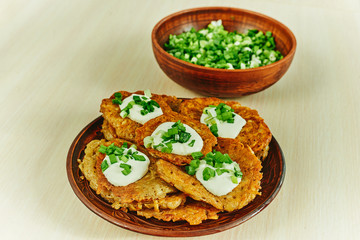 Draniki - a dish based on grated potatoes with the addition of flour, eggs, onions.