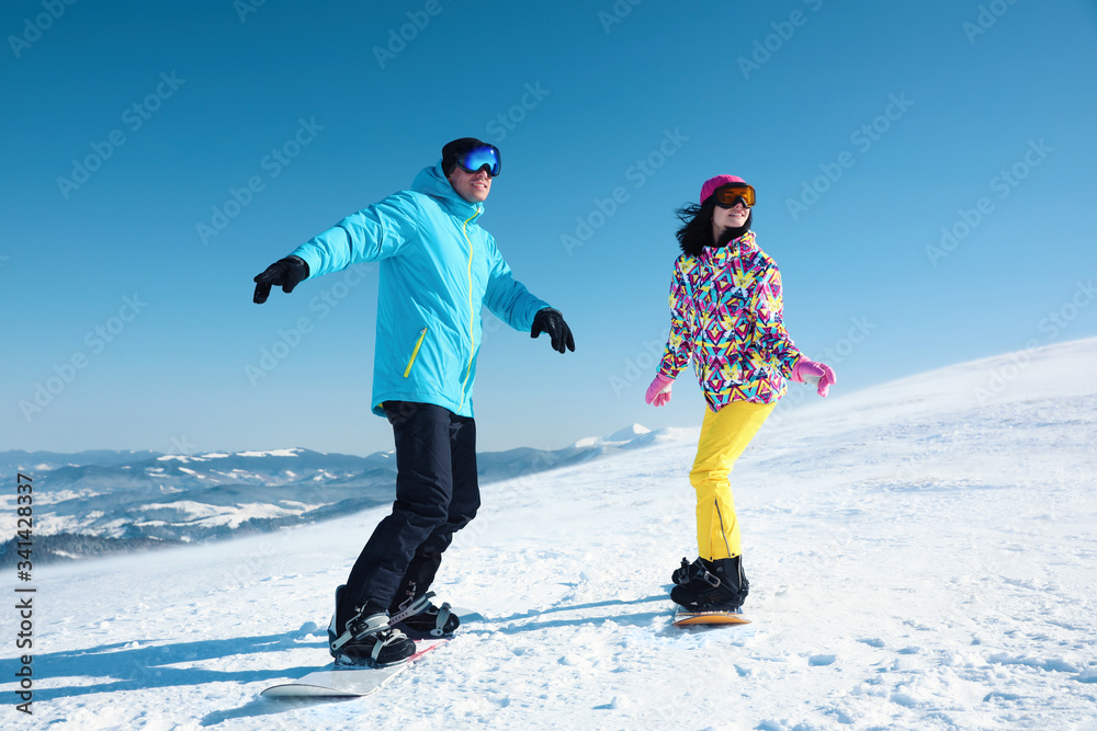 Sticker couple snowboarding on snowy hill. winter vacation