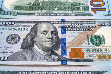 Close-up of one hundred US dollars. Many banknotes. A pile of bills of American dollars. Money...