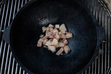 Pieces of lamb with onion are fried in boiling oil on the fire. As a stage in the preparation of...