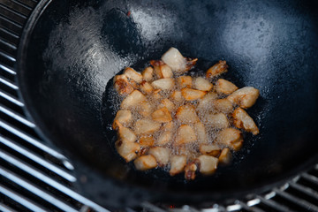 Pieces of lamb with onion are fried in boiling oil on the fire. As a stage in the preparation of...