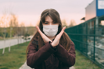 COVID-19 Pandemic Coronavirus Woman in city street wearing face mask protective for spreading of disease virus SARS-CoV-2. Girl with protective mask on face against Coronavirus Disease 2019.