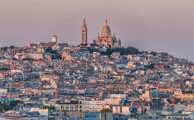 Fototapeta premium Aerial view of Paris cityscape with Basilica of the Sacred Heart of Paris (Basilique du Sacre Coeur) on Montmartre hill from the top of Triumphal Arch of the Star 