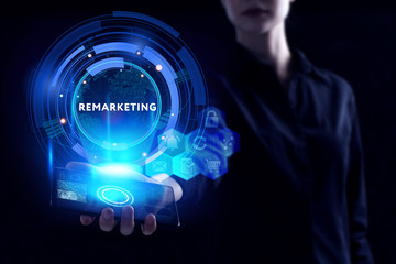 Business, Technology, Internet and network concept. Young businessman working on a virtual screen of the future and sees the inscription: Remarketing