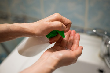 Prevention of the coronavirus pandemic: an adult woman puts antibacterial soap on her hands - 341430910