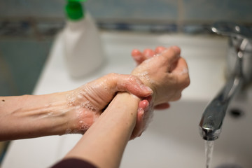 Adult woman washing hands with antibacterial soap. Hygiene concept. Prevent the spread of germs and bacteria and avoid infections corona virus - 341430942