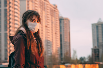 COVID-19 Pandemic Coronavirus Woman in city street wearing face mask protective for spreading of disease virus SARS-CoV-2. Girl with protective mask on face against Coronavirus Disease 2019.