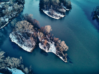 Panoramic aerial view: beautiful spring landscape: the Irtysh river in Kazakhstan wakes up from winter sleep - ice drift - snow and ice are melting at sunset