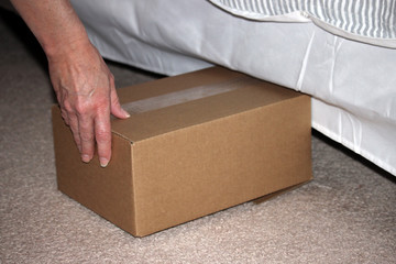storing cardboard box under bed