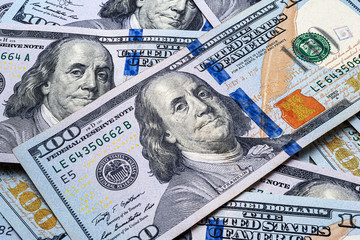 One hundred US dollar bills. Close up of many scattered banknotes. A pile of American dollars....