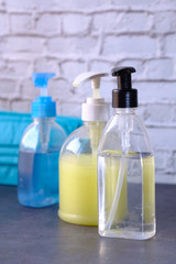 hand sanitizer and liquid soap on black background 