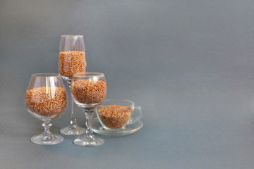 buckwheat food nutrition diet . buckwheat is poured into wine glasses on a gray background. deficit.