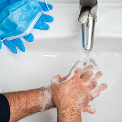 Fototapeta premium Coronavirus prevention. Hand washing with hot soapy water, the use of the mask and gloves prevents contagion from Covid-19. Top view. Health.