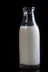 Homemade almond milk on the black background.