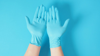 Empty two hand with doctor gloves on blue background.