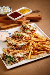 Skepasti chicken gyros with tomato, lettuce and pickles, potato fries on the side. Authentic Mediterranean dish photography in wooden table background. - 341437791