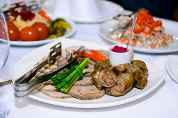 meat in a white plate on the table