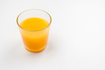 Glass of orange juice on a white background.