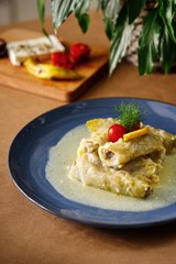 Ground beef rolled with pastry in white sauce presentable greek dish plating photography. Authentic Mediterranean cuisine.