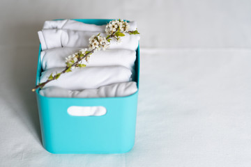 Man  brings wardrobe order puts everything on its place hides things in boxes. Closet organized....