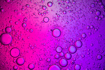 Abstract color background. Bubbles of oil in a colored liquid and lighting in macro photography. Creative and art concept