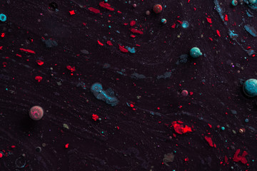 Amazing multi colored bubbles of paint on the oil surface.