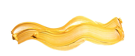 Gold acrylic paint brush stroke hand drawing texture isolated on white background top view photo...