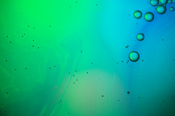 Abstract color background. Bubbles of oil in a colored liquid and lighting in macro photography. Creative and art concept