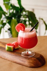 Healthy carrot fresh juice on elegant glassware in a wooden background. Authentic cuisine beverage options on menu.