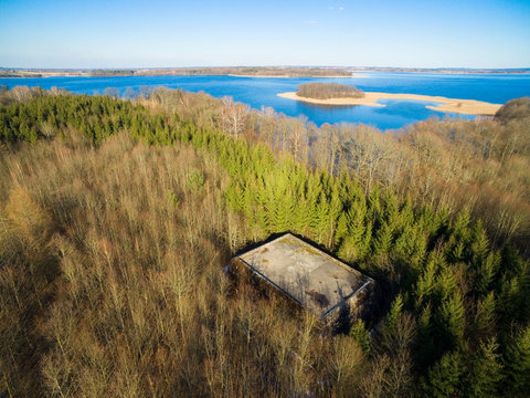 Aerial view of reinforced concrete bunkers belonged to Headquarters of German Land Forces from ww2 hidden in a forest on the Mamry Lake shore, Mamerki, Poland (former Mauerwald, East Prussia)