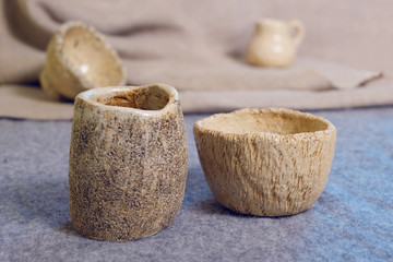 Kiev, Ukraine. January 10 2020.  Modern pottery. Decorative ceramic, clay plate. Handmade light pottery.  Set of ceramic, bowls, cup with background.