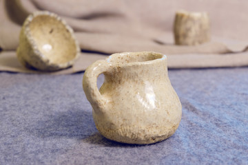 Kiev, Ukraine. January 10 2020.  Modern pottery. Decorative ceramic, clay plate. Handmade light pottery.  Set of ceramic, bowls, cup with background.