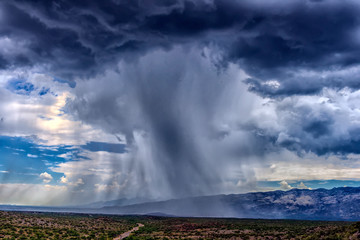 thunderhead cloud produces rain shower over semi-desert grassland prairie