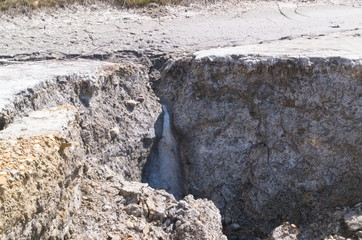 Kalush, Ukraine, 2020: Potassium salts withdrawal from soil. Gray soil, ore.